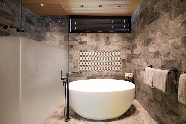 bathroom featuring wood ceiling, tile walls, and plus walk in shower