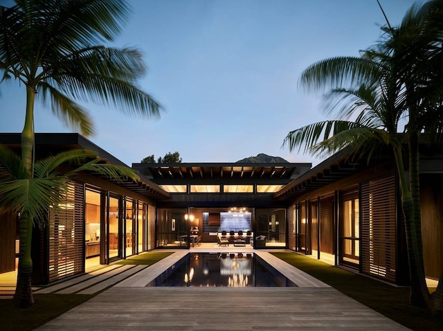 deck at dusk featuring a patio area