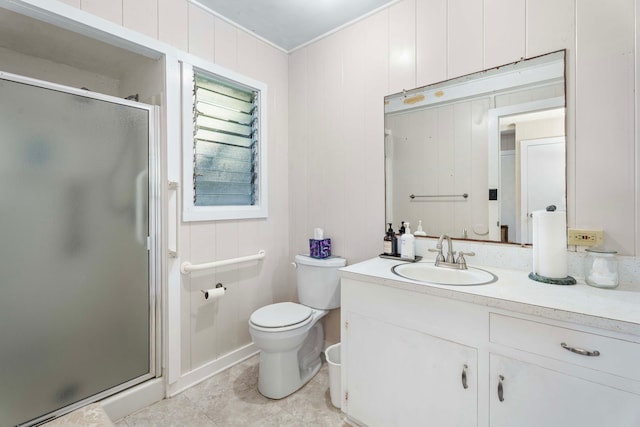 bathroom with tile patterned floors, walk in shower, ornamental molding, vanity, and toilet