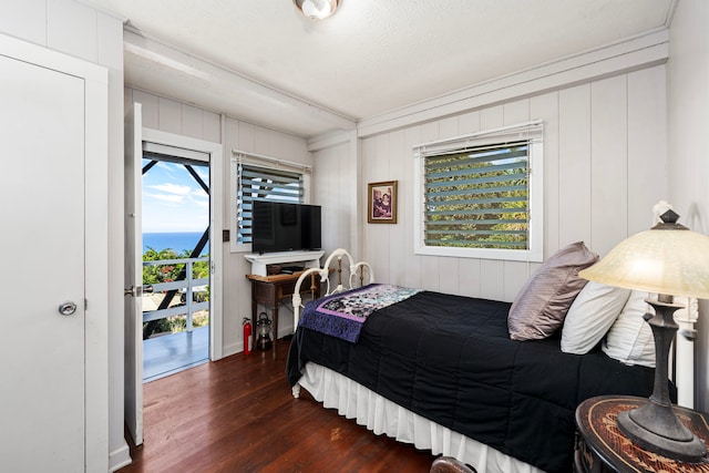 bedroom with dark hardwood / wood-style floors and a textured ceiling