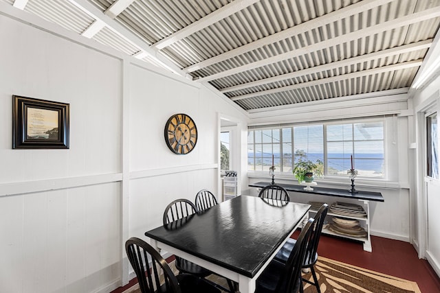 dining area with wood walls and dark hardwood / wood-style flooring