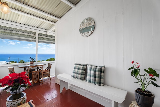 interior space featuring dark hardwood / wood-style flooring and a water view