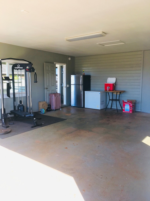 garage with fridge and stainless steel refrigerator