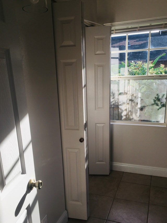 bathroom featuring a wealth of natural light and tile patterned flooring