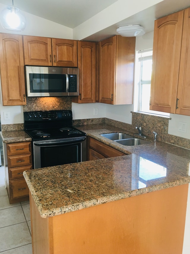 kitchen featuring light tile patterned floors, stone counters, sink, kitchen peninsula, and black electric range oven