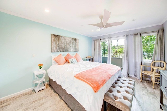 bedroom with crown molding, light hardwood / wood-style flooring, and ceiling fan