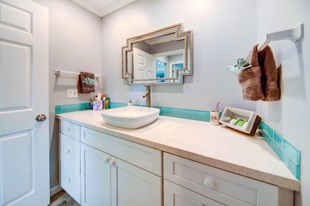 bathroom featuring ornamental molding, vanity, and wood-type flooring