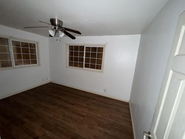 spare room featuring ceiling fan and dark hardwood / wood-style flooring