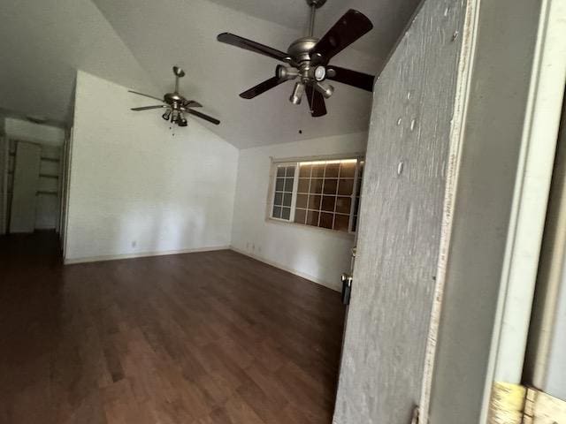 unfurnished room with ceiling fan, lofted ceiling, and dark wood-type flooring