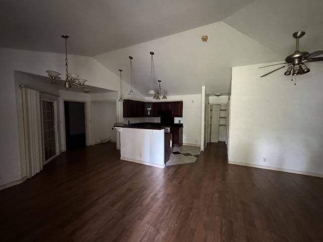 kitchen featuring ceiling fan with notable chandelier, vaulted ceiling, dark hardwood / wood-style floors, a kitchen island, and dark brown cabinetry