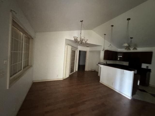 kitchen with ceiling fan with notable chandelier, dark hardwood / wood-style floors, dark brown cabinetry, and lofted ceiling