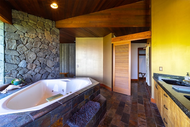 bathroom with wood ceiling, lofted ceiling, tiled bath, and vanity