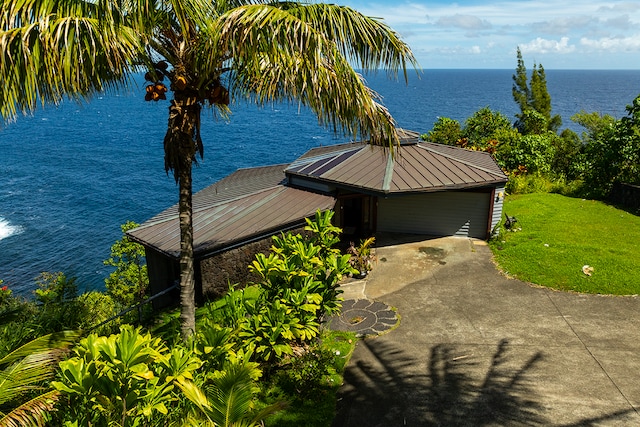 exterior space featuring a yard and a water view