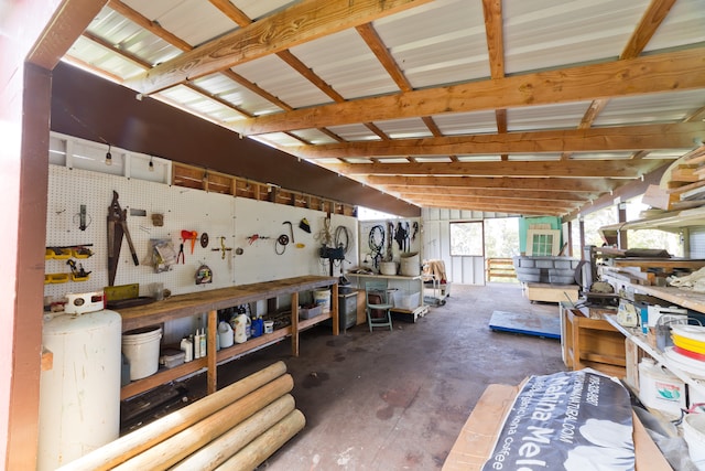 miscellaneous room with vaulted ceiling and a workshop area