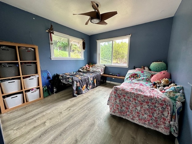 bedroom with ceiling fan and wood-type flooring