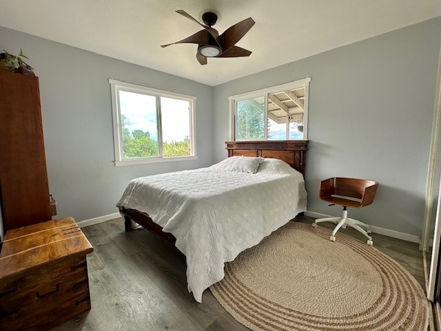 bedroom with ceiling fan and dark hardwood / wood-style flooring