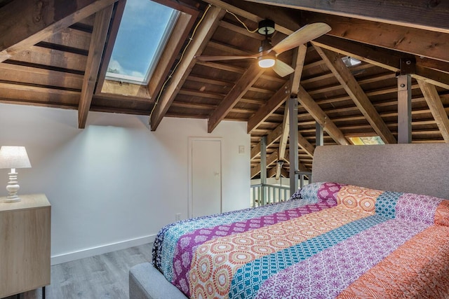 unfurnished bedroom with vaulted ceiling with beams, hardwood / wood-style flooring, ceiling fan, and wood ceiling