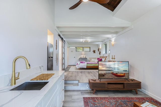 interior space featuring a barn door and sink