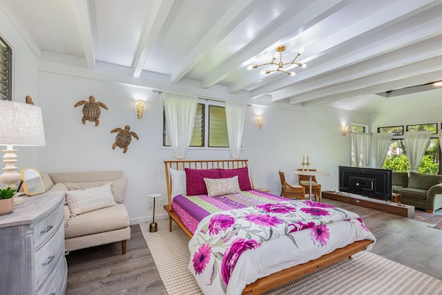 bedroom with hardwood / wood-style flooring, beam ceiling, and an inviting chandelier