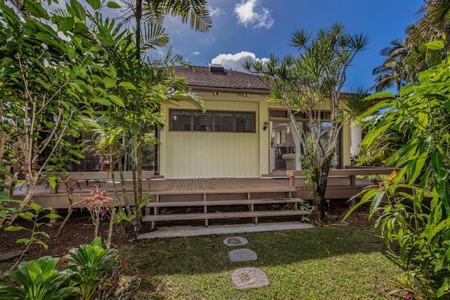 rear view of house featuring a wooden deck