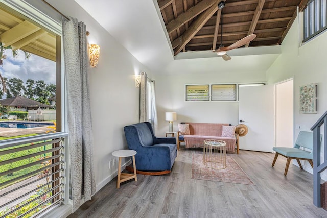 sitting room featuring hardwood / wood-style floors, vaulted ceiling with beams, and wood ceiling