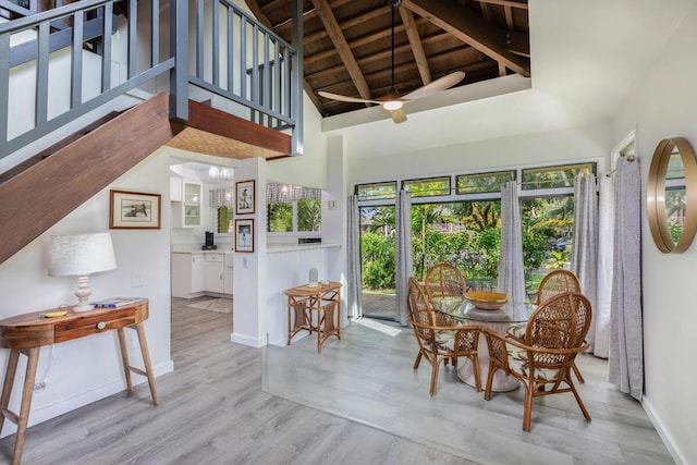 dining space featuring wood ceiling, high vaulted ceiling, light hardwood / wood-style flooring, a notable chandelier, and beamed ceiling