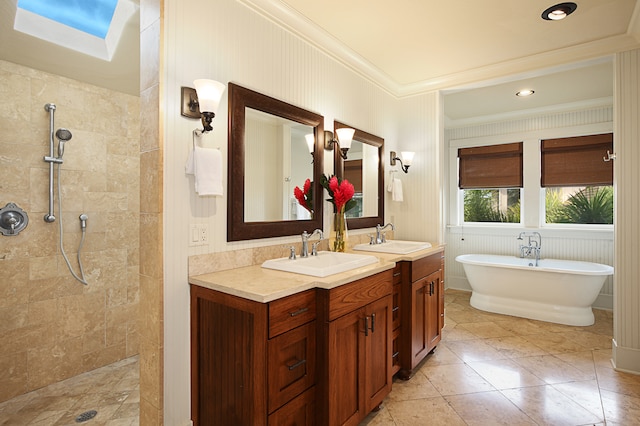 bathroom with shower with separate bathtub, tile patterned flooring, a skylight, ornamental molding, and vanity