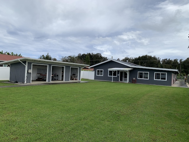 back of house featuring a lawn