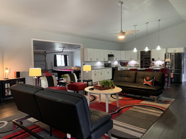 living room featuring ceiling fan, dark wood-type flooring, and vaulted ceiling