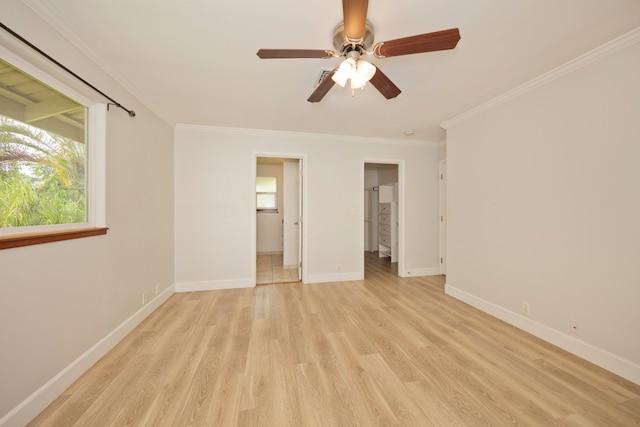 unfurnished bedroom featuring ceiling fan, ornamental molding, a spacious closet, ensuite bath, and light hardwood / wood-style floors