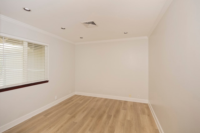 empty room featuring ornamental molding and light hardwood / wood-style floors