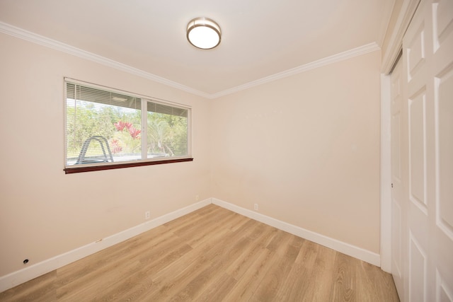 empty room with light hardwood / wood-style floors and ornamental molding