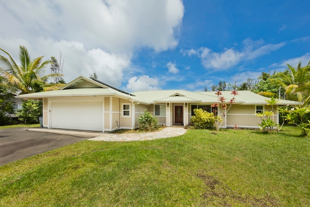 single story home with a garage, covered porch, and a front yard