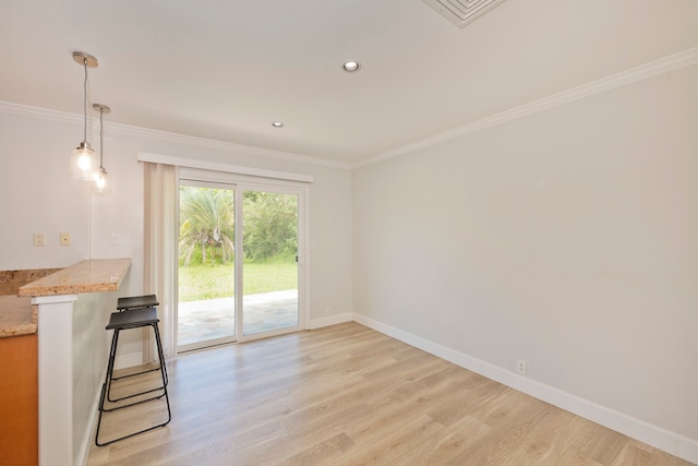 empty room featuring crown molding and light hardwood / wood-style floors