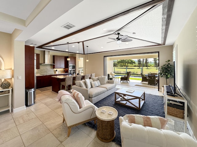 living room featuring beam ceiling, light tile patterned floors, and ceiling fan