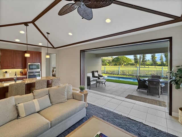 tiled living room with ceiling fan, lofted ceiling, and sink