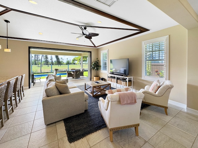 tiled living room with beam ceiling, a wealth of natural light, and ceiling fan