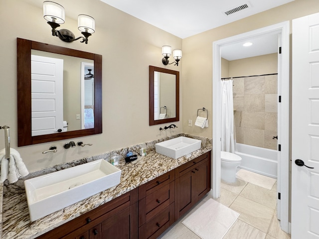 full bathroom with tile patterned flooring, shower / tub combo with curtain, vanity, and toilet