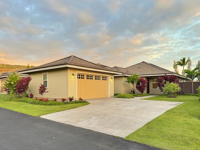 view of front of house with a yard and a garage