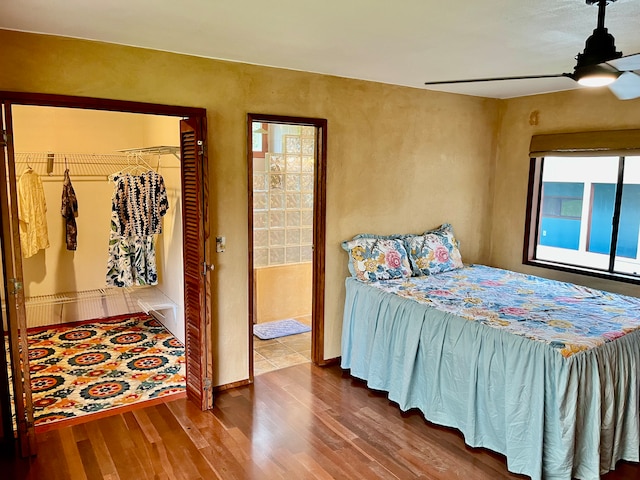 bedroom with wood-type flooring, a closet, and ceiling fan