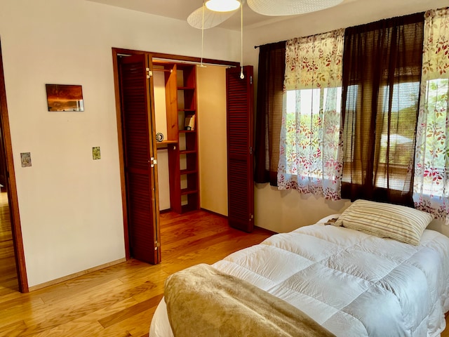 bedroom featuring a closet, ceiling fan, and hardwood / wood-style flooring