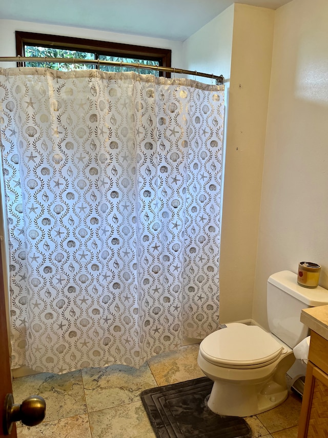 bathroom with vanity, toilet, and curtained shower