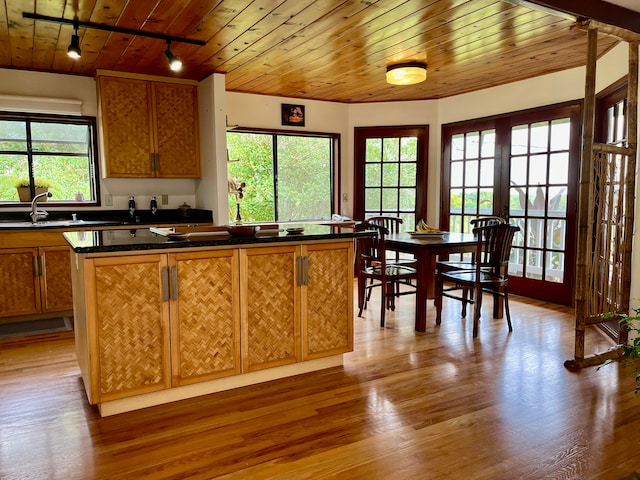 kitchen featuring wooden ceiling, a healthy amount of sunlight, hardwood / wood-style floors, and rail lighting