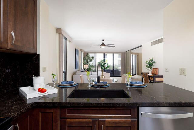 kitchen featuring decorative backsplash, dark stone countertops, dishwasher, ceiling fan, and dark brown cabinetry