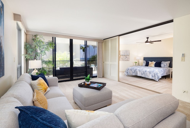 bedroom with french doors, floor to ceiling windows, access to exterior, and ceiling fan