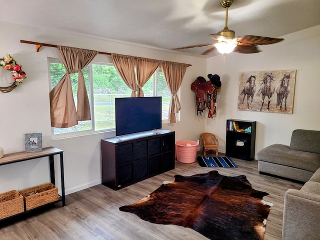 living room featuring light wood-type flooring and ceiling fan