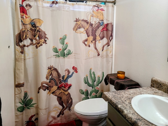 bathroom with vanity, toilet, and walk in shower