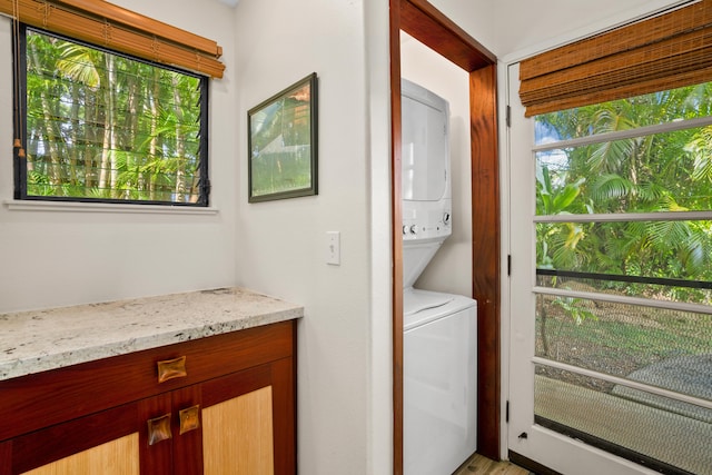 laundry room with stacked washer and dryer