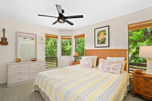 bedroom featuring ceiling fan and light carpet