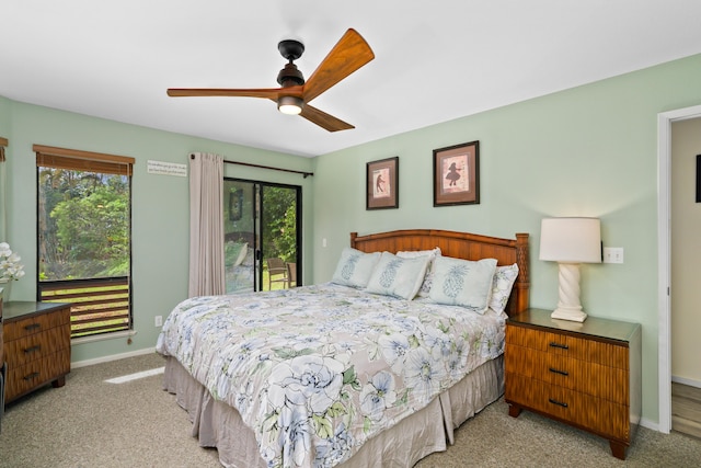 carpeted bedroom with multiple windows, access to outside, and ceiling fan